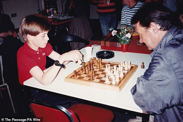 William played chess during his visit to homeless charity The Passage with his mother.