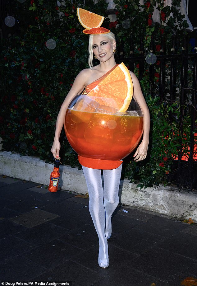 Pixie Lott in her Aperol Spritz Halloween costume, which she wore to a party at Annabel's private club in Mayfair last week.