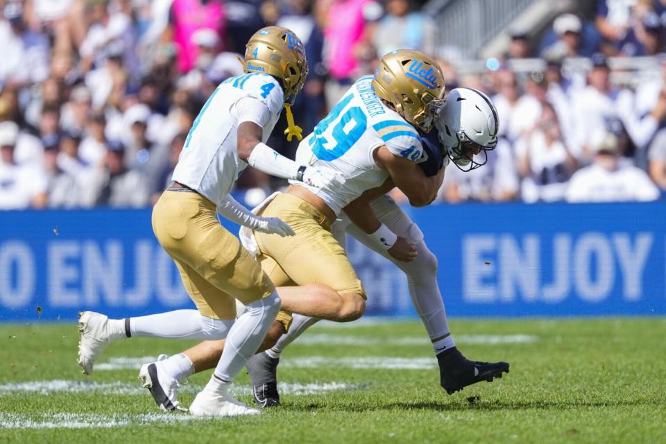 UCLA linebacker Carson Schwesinger tackles Penn State quarterback Beau Pribula