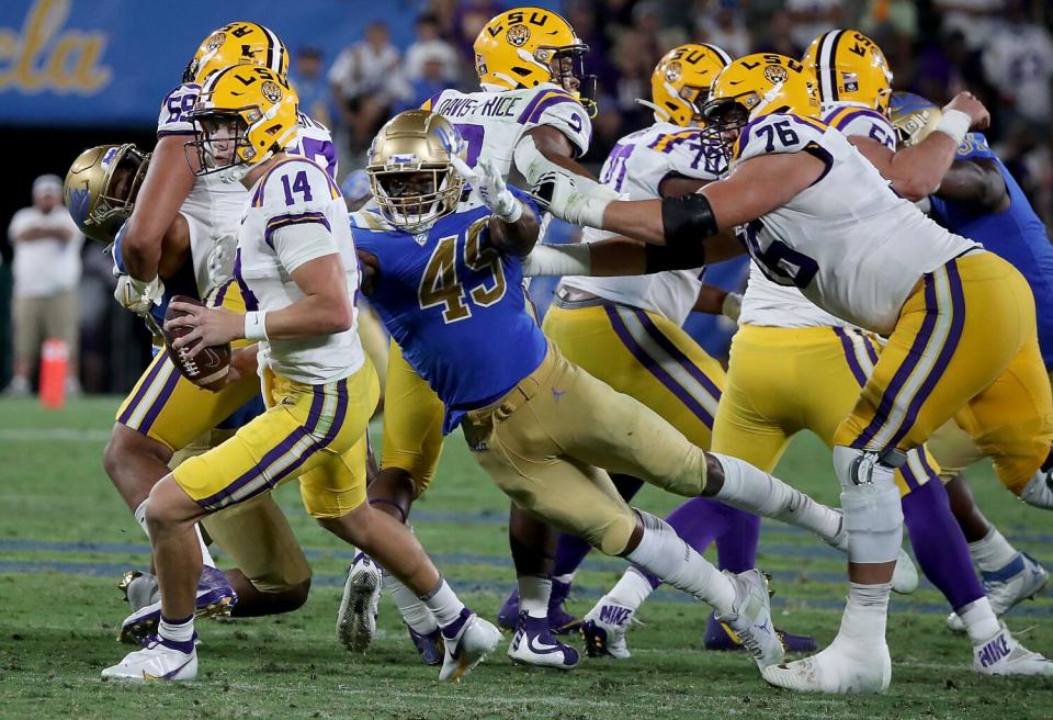 UCLA linebacker Carson Schwesinger pressures LSU quarterback Max Johnson in the Rose Bowl on Sept. 1, 2021.