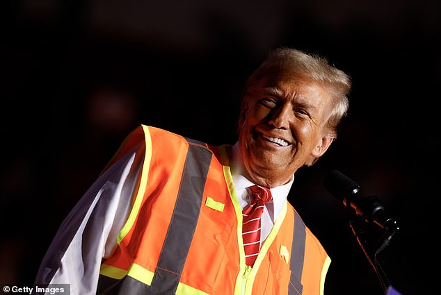 Trump wore a garbage collector's high-visibility vest at his rally in Wisconsin on Wednesday night, as he tries to keep comments about his supporters being 