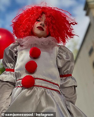 Sam donned a comical Chucky mask over his head and wielded a fake knife, while three of his four children sported their own spooky trick-or-treating outfits.