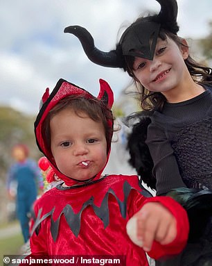 One of their children was dressed in an IT costume, while two others dressed as Maleficent and an imp. in the photo