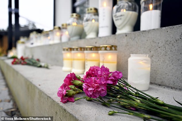 Pictured: Candles and flowers were placed outside the apartment where Janne was killed in tribute to the athlete.