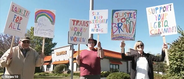 Protesters are seen here outside the restaurant in support of Livingston and his claims.