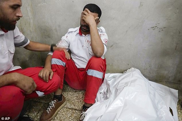 The Palestinian ambulance worker sat in the morgue next to Samira's body with his head in his hands.