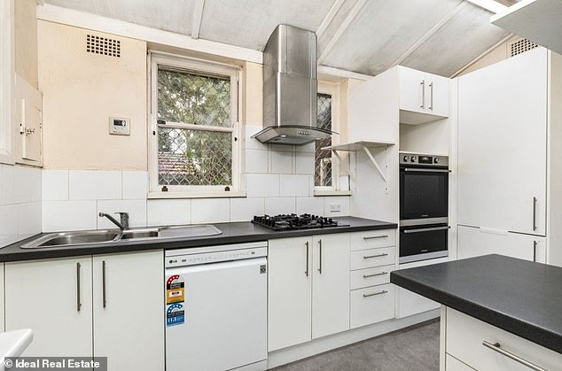 The kitchen (pictured) of the house also has stains from mold or smoke, or possibly both.