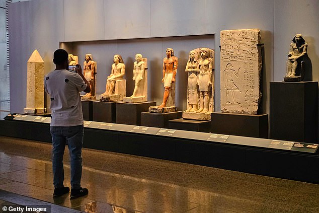 Visitors will have to wait to catch a glimpse of Tutankhamun's treasures. The ancient pharaoh's gold mask and sarcophagus are still in the original museum in Tahrir Square, while items that have been moved are not yet on display. Above: pharaonic statues in the new museum.