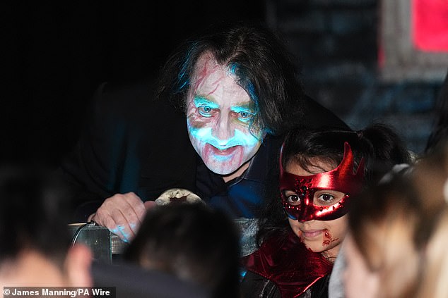 Jonathan posed for photos with children dressed in spooky costumes.