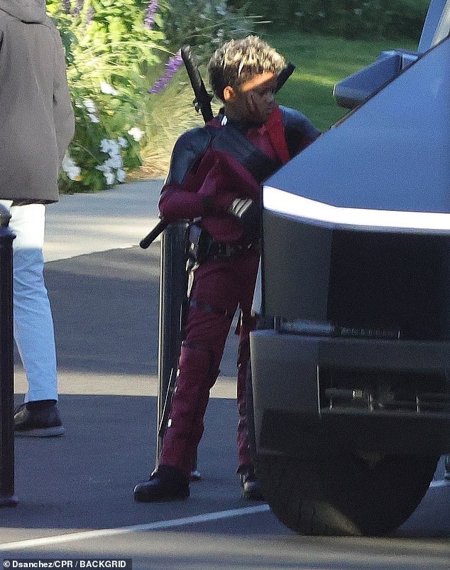 Eight-year-old Son Saint showed off his love for superheroes in a red and black Deadpool costume.