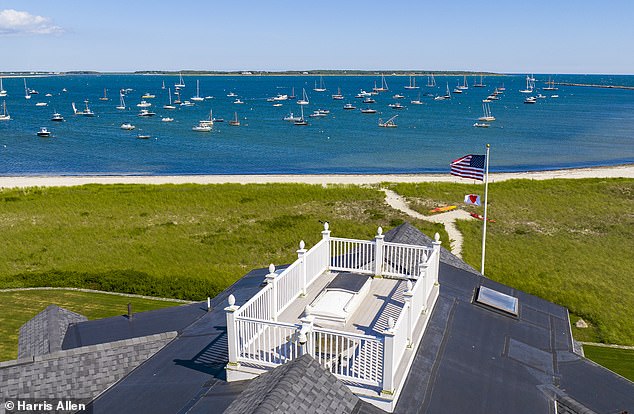 Screened by tall, finely manicured hedges and a gated driveway, the only view of the home outside of the opulent oasis is from the home's other striking feature, a rooftop terrace with widow's walk.