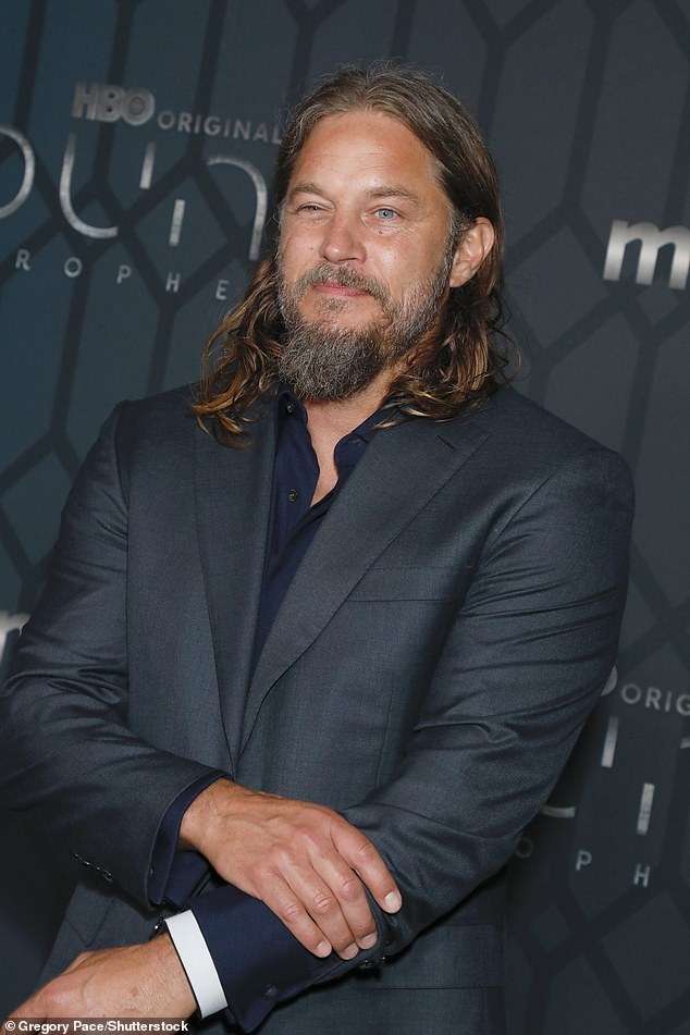 Looking dapper in a gray suit, the Vikings star's outfit was complemented by his shaggy gray beard and a longer goatee that highlighted his rugged features.