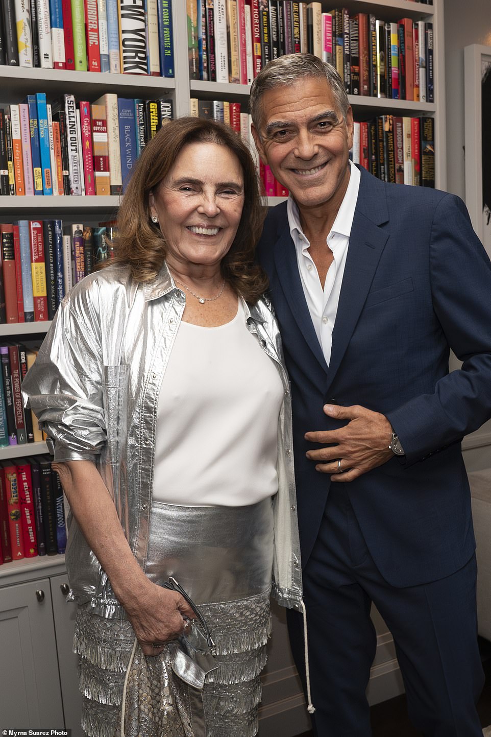 Clooney also posed with a woman in a dynamic silver suit with a white shirt.