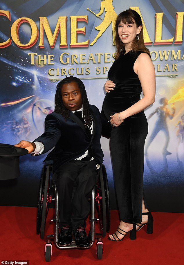 The Paralympic athlete, 51, joined fellow singer Linda, 34, to attend the world premiere of Come Alive The Greatest Showman in London on Wednesday night, where he proudly showed off his baby bump.