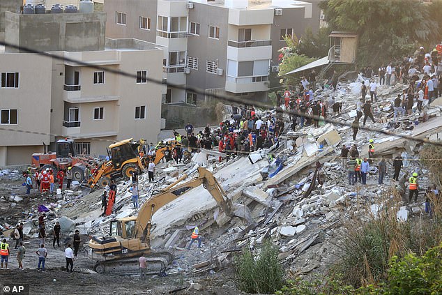 Rescuers search for victims after an Israeli airstrike hit two adjacent buildings, in the Ain el-Delb neighborhood, east of the southern port city of Sidon, Lebanon.