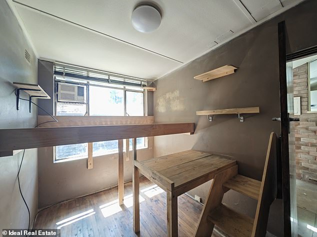 A strange 'third bedroom or study' (pictured) features random fragments of wooden shelving