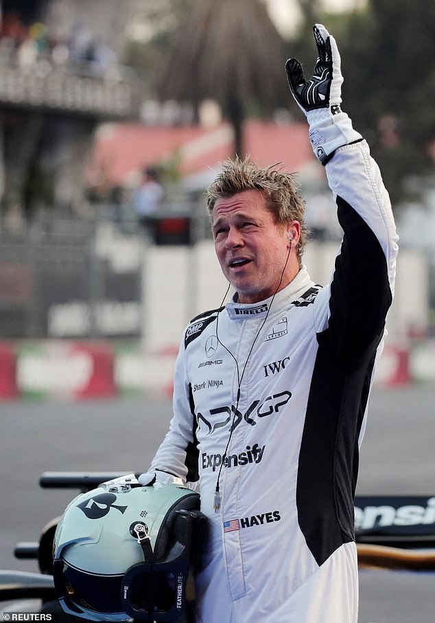 The 60-year-old actor wore a white racing suit while filming scenes for his upcoming F1 movie.