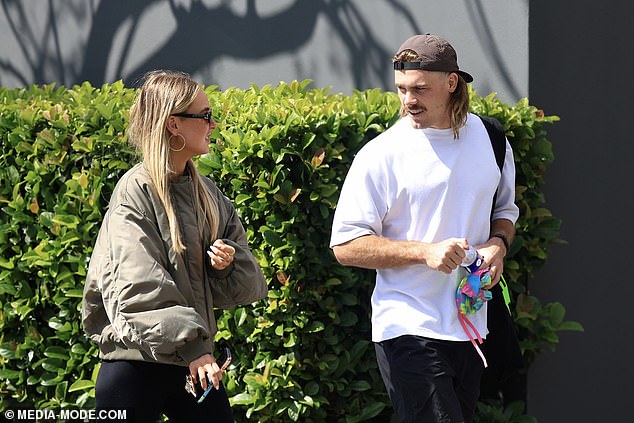 The couple seemed happy to be in each other's company, smiling as they walked down a tree-lined Sydney street.