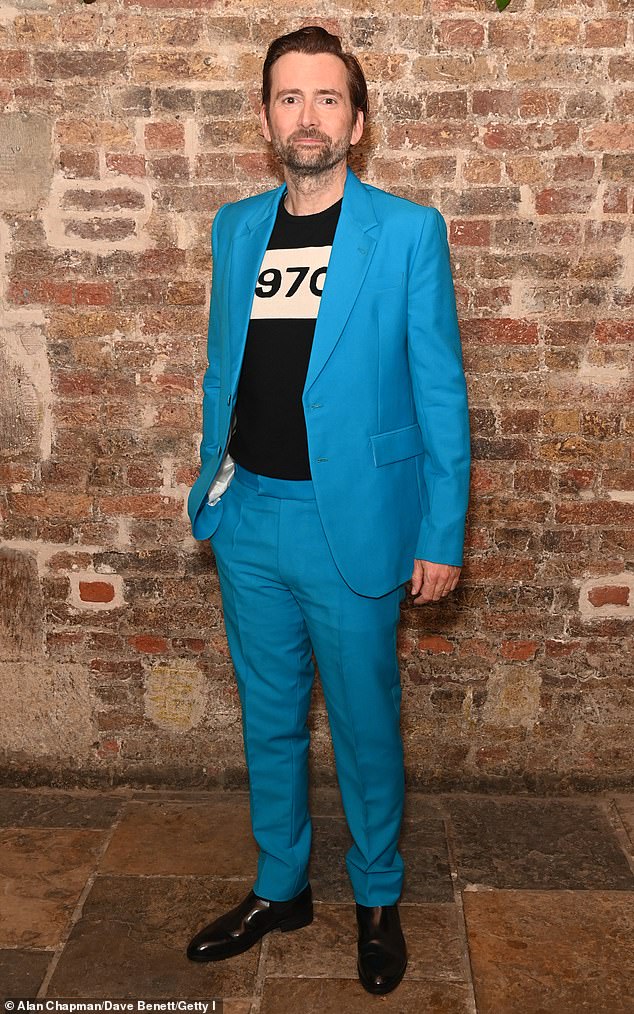 David put on a vibrant display in his striking suit and graphic logo t-shirt.