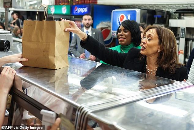 Vice President and Democratic presidential candidate Kamala Harris grabs food at a stop at the famous 4th Street Delicatessen while campaigning in Philadelphia, Pennsylvania.