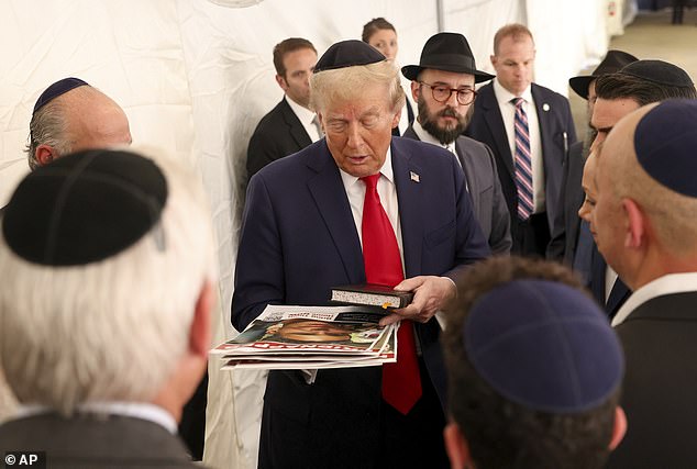 Republican presidential candidate former President Donald Trump speaks with members of Chabad Lubavitch after visiting the grave of Rabbi Menachem Mendel Schneerson, Monday, Oct. 7, 2024, in New York.