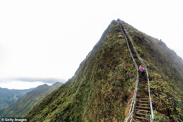 A file image shows a female hiker climbing the steep and treacherous mountain route.