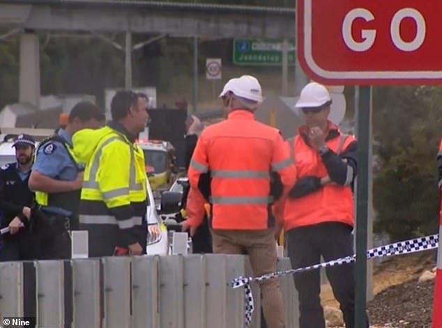 Pictured are some of Breslin's colleagues at the scene after the fatal accident.