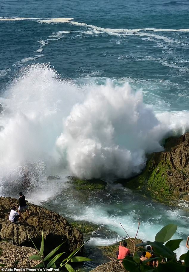 Horror images captured the moment the tourist was swept away by the huge wave while posing for photographs at the coastal location.