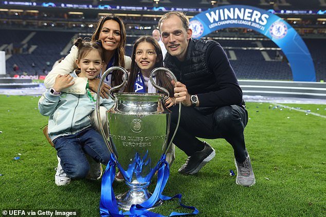 The family is seen posing next to the 2021 Champions League trophy in Porto