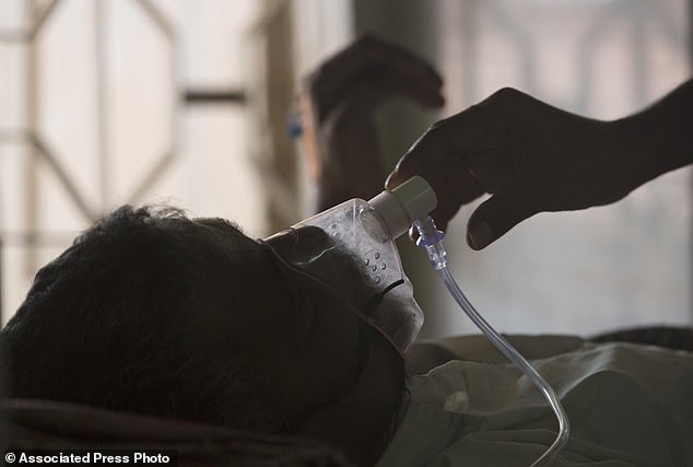 Bacterial lung infection cases soared to a record 8.2 million in 2023, according to the World Health Organization. Here, a family member adjusts the oxygen mask of a tuberculosis patient at a tuberculosis hospital in Hyderabad, India, earlier this year.