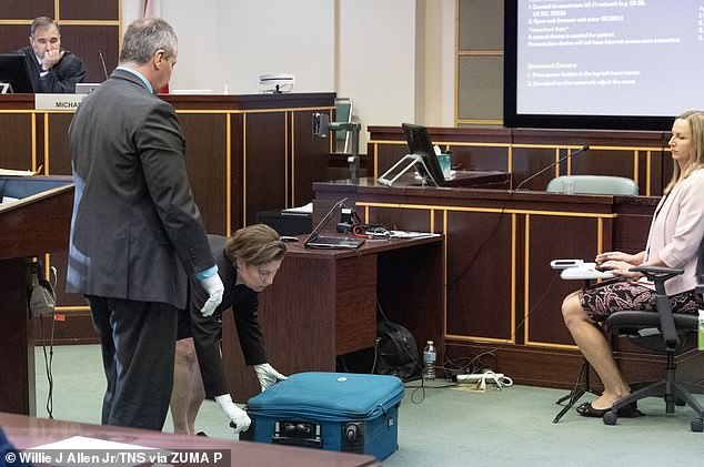 Boone is seen demonstrating how he put Torres in the bag for the jury during his trial.