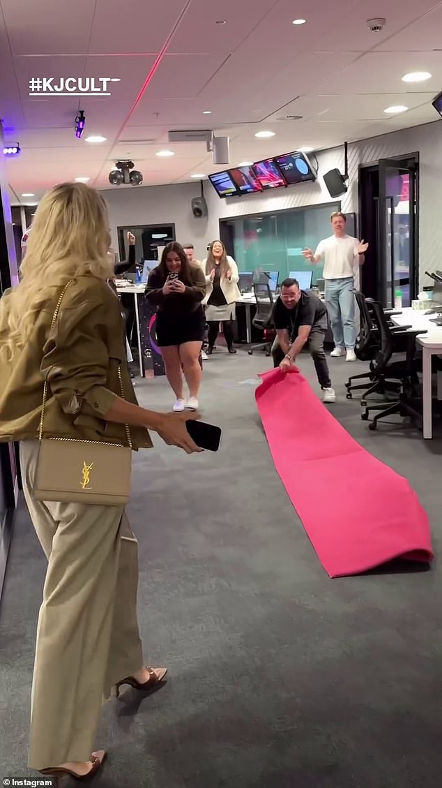 A video then showed a crowd of staff chanting and clapping 'Jackie O!' and rolling out a pink carpet for the presenter's arrival at the station's North Sydney office.