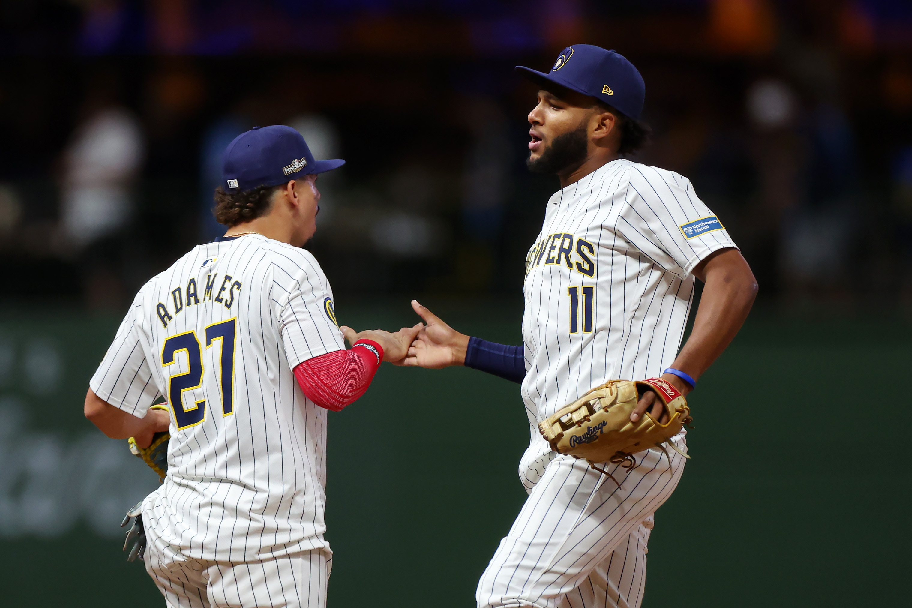 MILWAUKEE, WISCONSIN – OCTOBER 2: Willy Adames #27 and Jackson Chourio #11 of the Milwaukee Brewers celebrate after beating the New York Mets 5-3 in game two of the Wild Card Series at American Family Field on October 2, 2024 in Milwaukee. Wisconsin. (Photo by Stacy Revere/Getty Images)