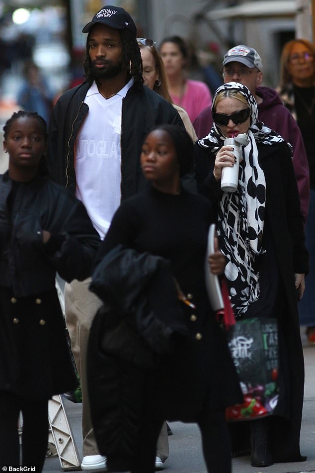 The lovebirds were accompanied by their adopted twin daughters, who wore matching black dresses.