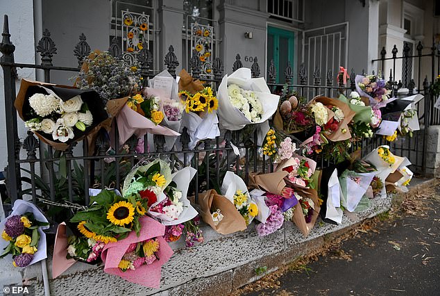 Floral tributes were left for the couple outside Mr Baird's terraced house in Paddington (pictured)