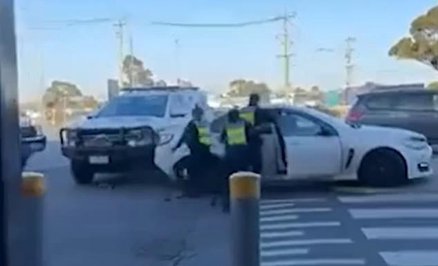 Three police officers desperately tried to pull the man from behind the wheel of the car but were unable to stop him.