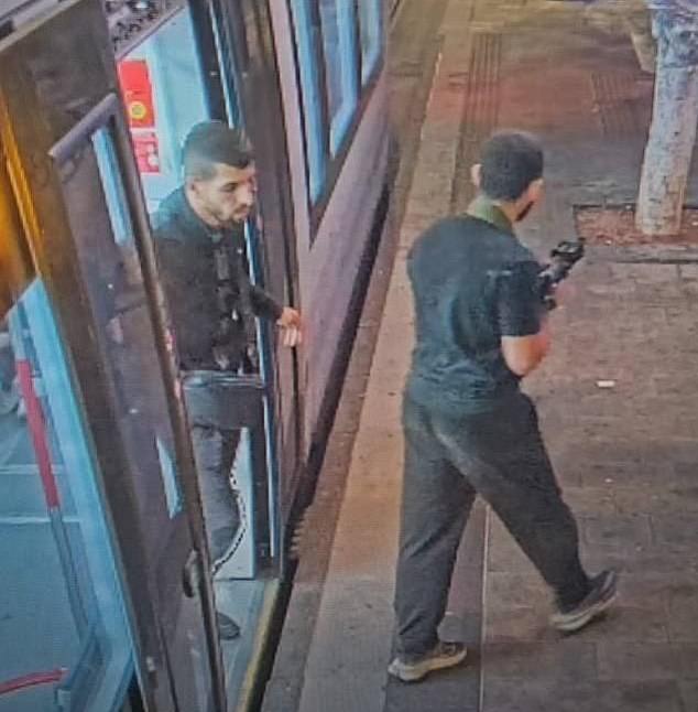 Two armed men on the streets of Tel Aviv during the attack.