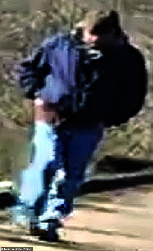 The video showed a man, wearing a blue jacket, jeans and a hat, walking behind the girls.