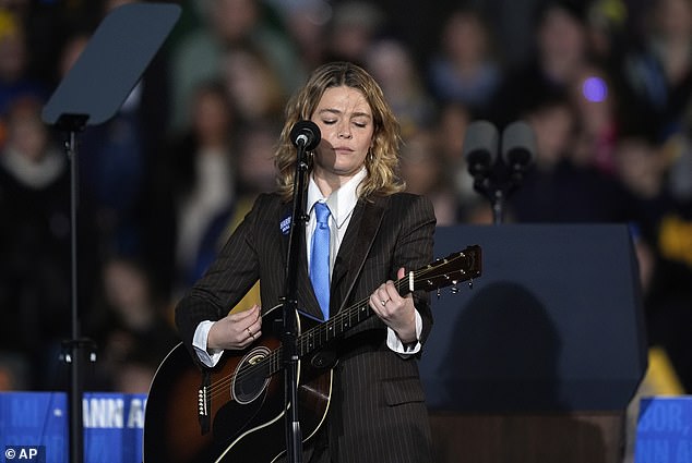 Singer Maggie Rogers waves to the crowd during a Kamala Harris rally where she performed. He said nothing is more important than the election right now.