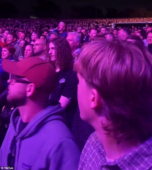 A member of the crowd can be seen shouting at other concertgoers in what appears to be a protest over the war in Gaza.