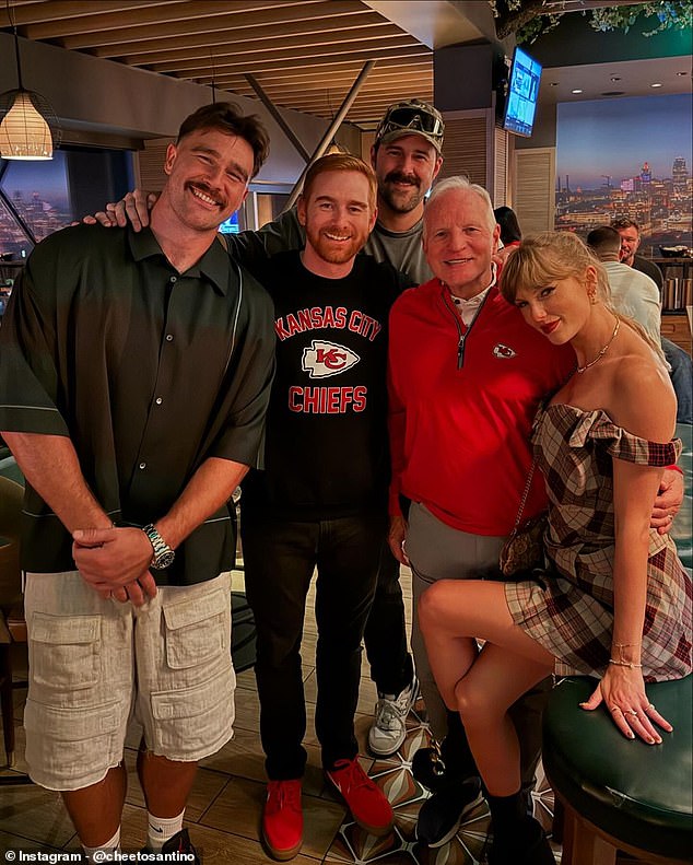 The loving couple posed for a photo with comedian Andrew Santino (second from left)