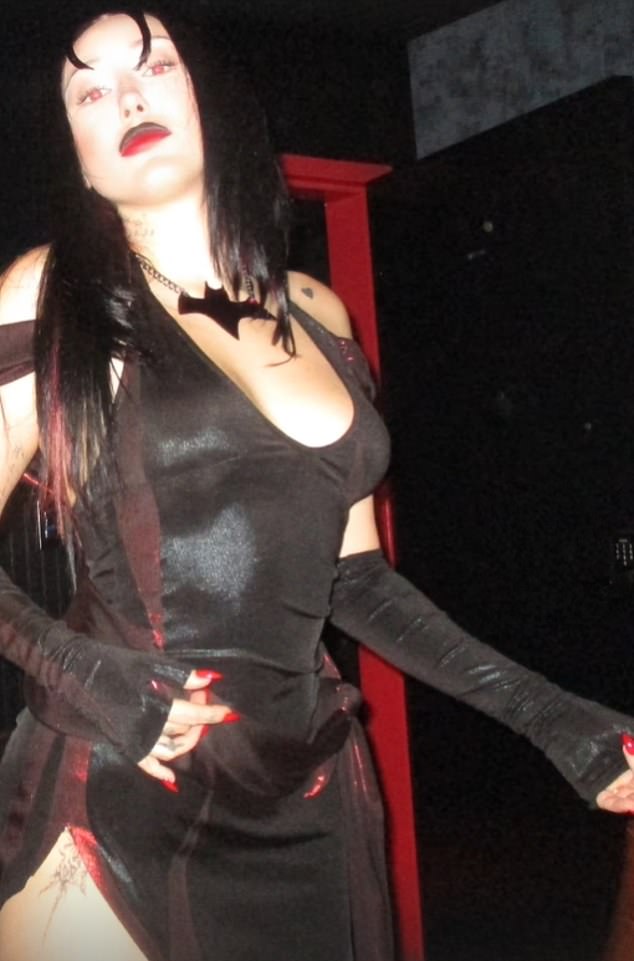 She emphasized her curves in a form-fitting black dress with opaque red details, paired with fingerless opera gloves to show off her blood red nail polish.