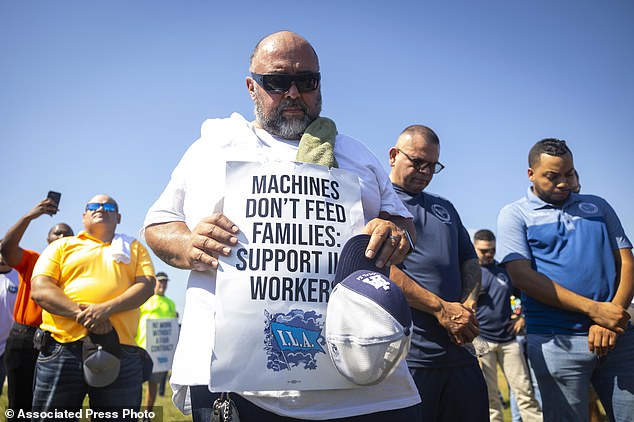 Longshoremen bow in prayer during a strike at the Bayport container terminal