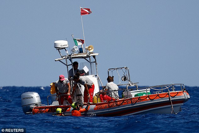 Rescue personnel and divers operate a search on August 21 off the coast of Porticello.