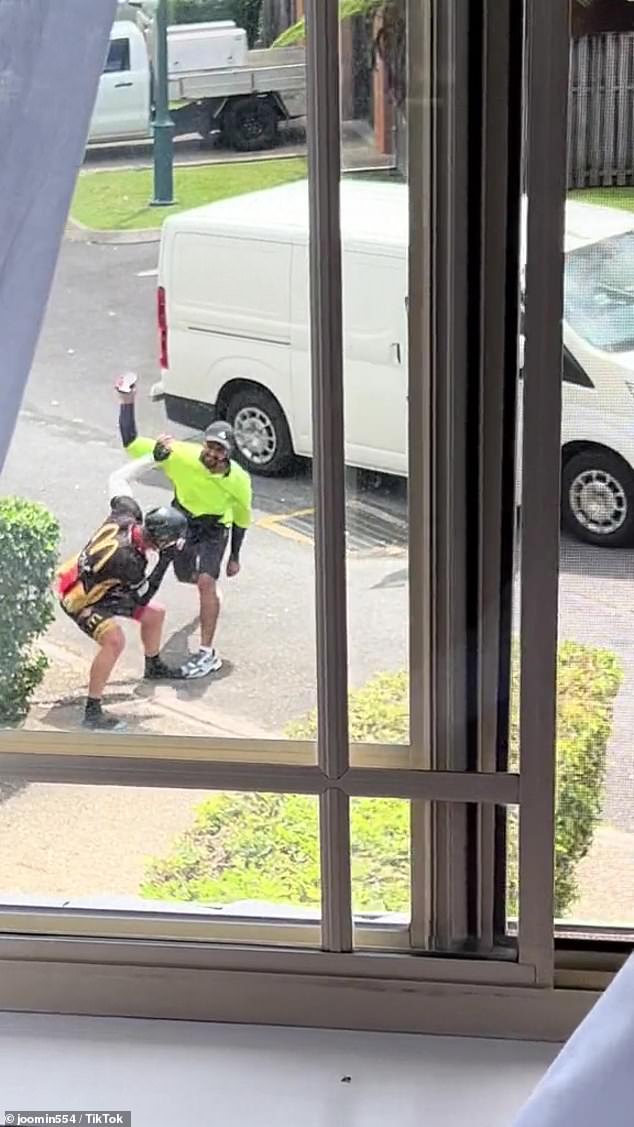 The cyclist and the postman continued to exchange blows, and at one point the postman threw his scanner at the man before finally admitting defeat (pictured).