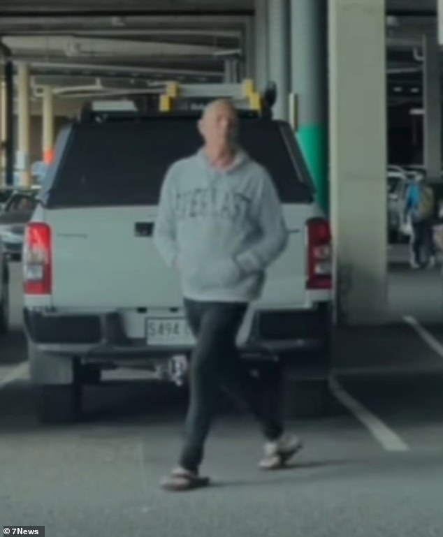 He approached the car, believed to be a Tesla, in broad daylight at Westfield Marion (pictured).