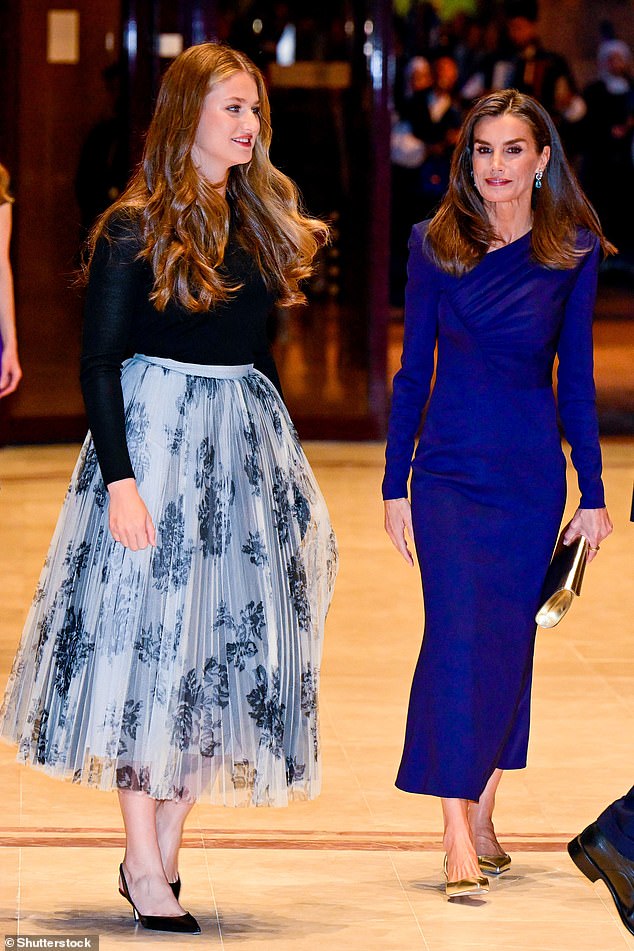 Leonor (left), 18, wore a flower-printed tulle skirt that perfectly complemented her mother Letizia's (right) royal blue dress.