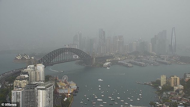 The Sydney Harbor Bridge and Opera House are shrouded in clouds and fog on Monday.