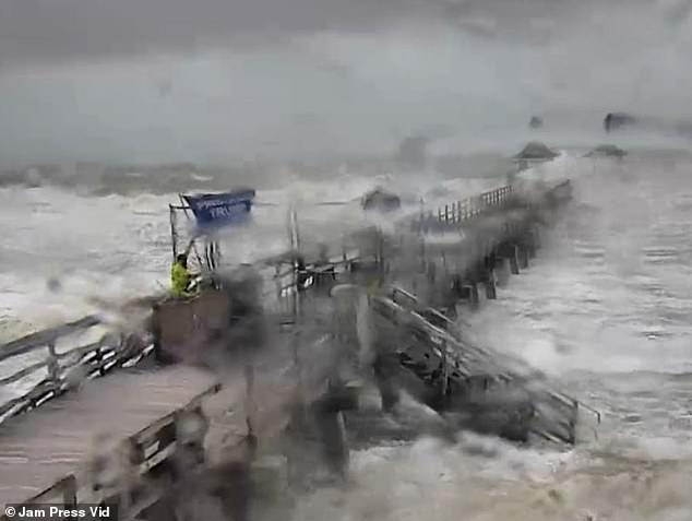 A man braved Hurricane Milton on Wednesday to plant a Trump 2024 flag on a pier in Naples, Florida, as strong winds and waves battered the pier.