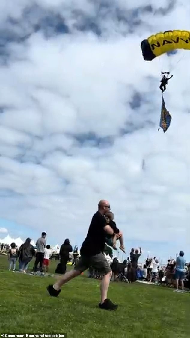 A snippet of video from the Mia incident captures the stray skydiver veering toward disaster. A father appears to be pulling off the road while carrying his son